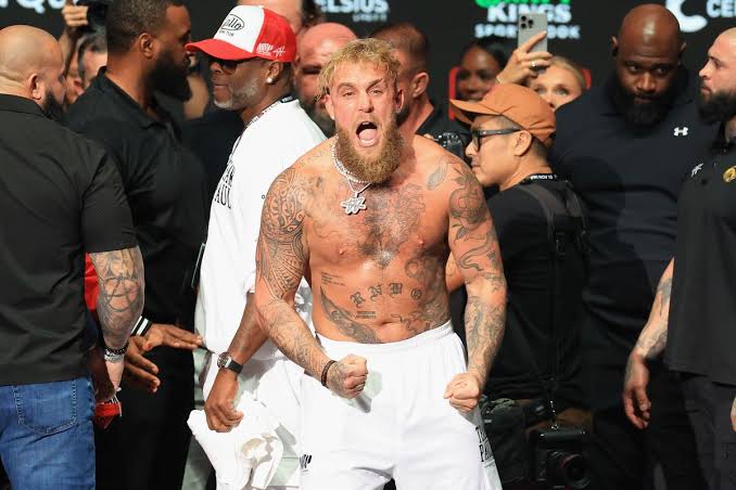 Jake Paul vs Chavez Jr : Jake Paul shirtless and shouting with fists clenched during a weigh-in event
